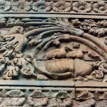 Delaminated stone surfaces along the base plinth of the Dhamek stupa.